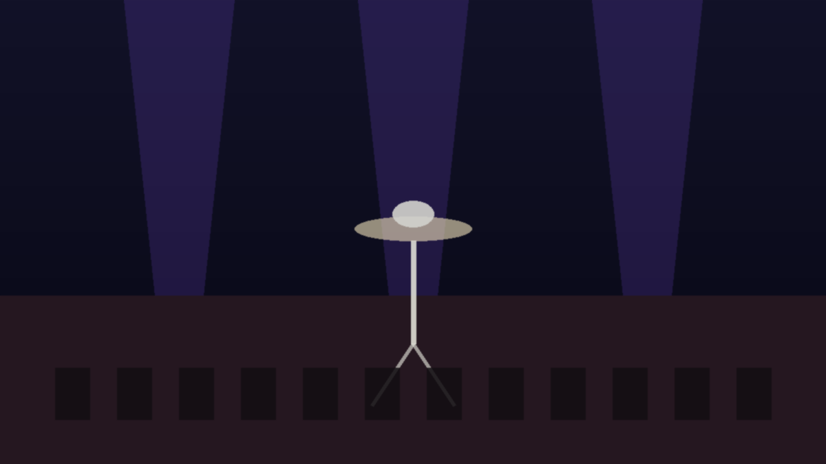 An empty historic music theater stage with spotlight and microphone stand